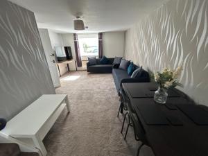 a living room with a couch and a table at Sleeps4-FamilyFriendly-FreeParking- Nc500 in Wick