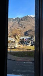 a view of a mountain from a window at Beau studio cosy in Randens +5 photos