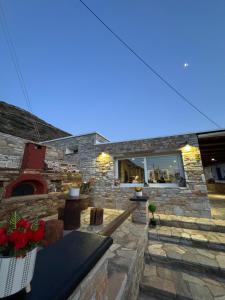 a stone patio with a table and chairs at Dream catcher 4 in Ios Chora