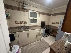 a small kitchen with a sink and a stove at الرحاب سيتي in New cairo