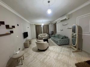 a living room with a couch and a chair at الرحاب سيتي in New cairo