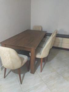 a wooden table with two chairs and a wooden table and chairs at الرحاب سيتي in New cairo +5 photos