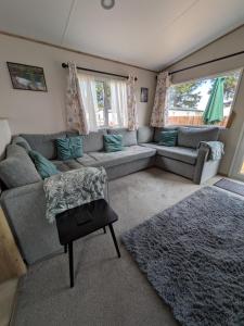 a living room with a couch and a rug at Boat 32 in Boat of Garten