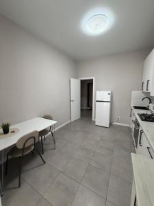 an empty kitchen with a table and a refrigerator at Яровиця 167 in Lutsk +3 photos
