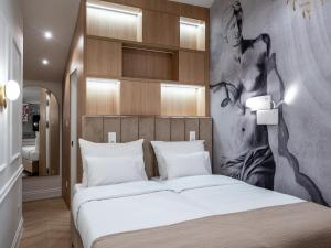 a bedroom with a bed with a painting on the wall at Agava Design Residence in Split +66 photos