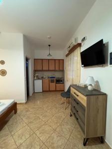 a living room with a table and a tv on the wall at Dream catcher 4 in Ios Chora