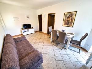 a living room with a couch and a table at Apartments Benkovic in Baška
