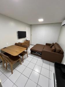 a living room with a couch and a table at Gran Lençóis Flat Residence Barreirinhas in Barreirinhas