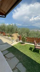 a patio with a bench in a yard with a fence at Guest House Mario in Berat