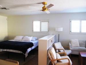 a bedroom with a bed and a ceiling fan at Quail's Nest - Downtown Studio in Tucson