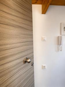 a door in a room with a wooden floor at Ocean Breeze Luxury Loft in Psathopyrgos