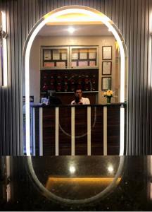 a man taking a picture of himself in a mirror at Derya Hotel in Mersin