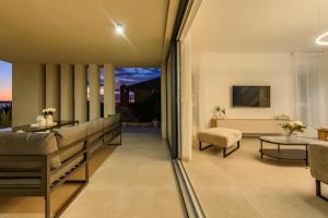 a living room with a couch and a table at Villa Infinity in Rtina