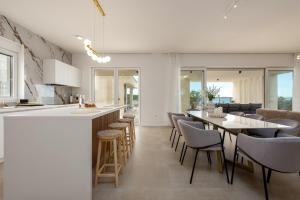 a kitchen and dining room with a table and chairs at Villa Infinity in Rtina +15 photos