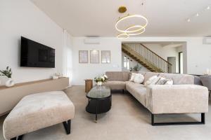 a living room with a couch and a table at Villa Infinity in Rtina