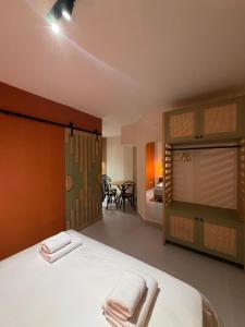 a bedroom with a bed with two towels on it at D'stay by Dastid in Golem