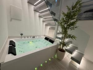 a bathroom with a hot tub with a potted plant at Acqua e Sale in Gallipoli