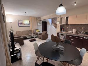 a kitchen and a living room with a table and chairs at Villa Bella Sozopol in Sozopol