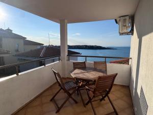 a table and chairs on a balcony with a view of the ocean at Villa Bella Sozopol in Sozopol