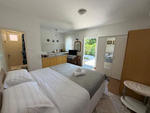 a bedroom with a bed with a towel on it at Studio Apartman ISRA 1 in Palit