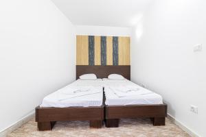 a bedroom with a bed in a white room at Aparthotel HayatHills in Sarajevo