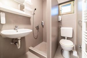 a bathroom with a toilet and a sink at Aparthotel HayatHills in Sarajevo +67 photos