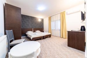 a hotel room with a bed and a table at Aparthotel HayatHills in Sarajevo