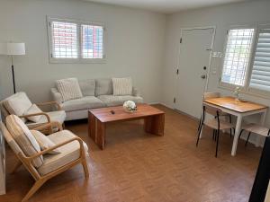 a living room with a couch and a table at Quail's Nest - Downtown Studio in Tucson