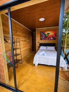 a room with a bed and a ladder in it at Coffee House Minca in Minca