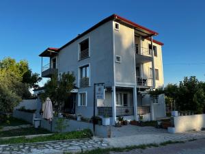 a white building with a umbrella in front of it at Bavella House in Pamukkale