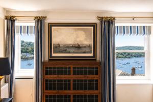 a room with two windows with curtains and a painting at An Glas Bras - By Rowes Retreats in Falmouth