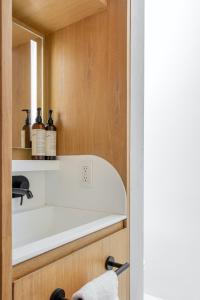 a bathroom with a shelf with bottles of wine at Octavia Casa in Mexico City +49 photos