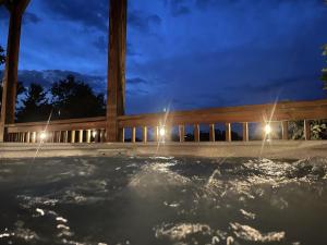 a jacuzzi tub at night with lights at Rustic Cabin, Fire Pit with HotTub, Mountain Views, Peaceful Location in Sevierville