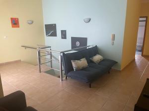 a living room with a couch and a table at Refúgio Das Ondas in Praia da Vitória