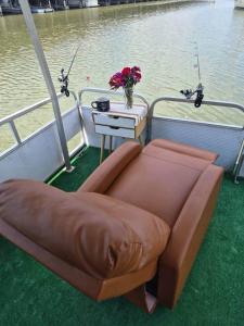 a brown couch sitting on the back of a boat at Knot Work Cayuga Lake 30ft Boat in Ithaca