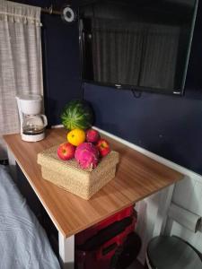 a table with fruit on it in a bedroom at Knot Work Cayuga Lake 30ft Boat in Ithaca