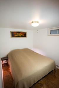 a bed in a room with a painting on the wall at Villa floor with patio in Södertälje