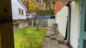 a view of a yard with a tree and a house at Villa floor with patio in Södertälje