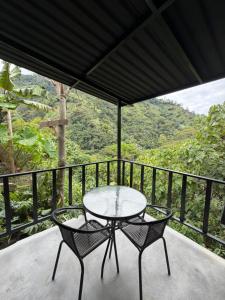 a table and two chairs on a balcony with a view at Animadbali1 in Ibagué