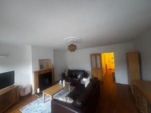 a living room with a couch and a table at Dublin 12 house in Dublin