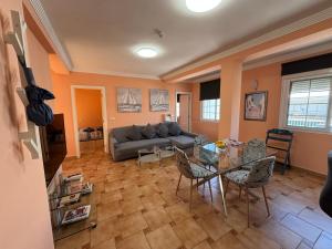 a living room with a couch and a table at Las Delicias de Estepona in Estepona