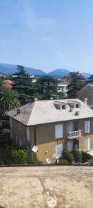 a large house in front of a building at La Petite in Cogoleto