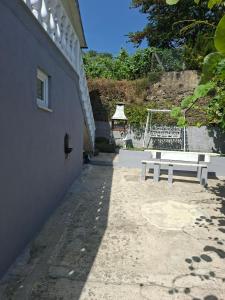 a white bench sitting next to a building at HOUSE DOURO in Peso da Régua
