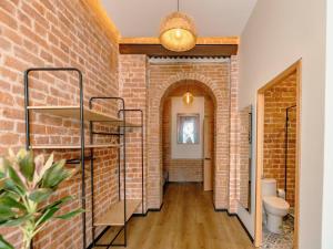 a hallway with a brick wall and a toilet at Hotel Terracota mx in Mexico City +176 photos
