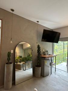 a living room with a table and a mirror at Animadbali1 in Ibagué