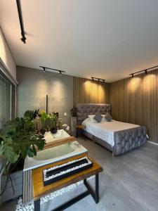 a bedroom with a bed and a piano in it at Animadbali1 in Ibagué