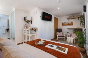 a living room with a couch and a table at Studio with Terrace & Stunning Views in Güéjar-Sierra