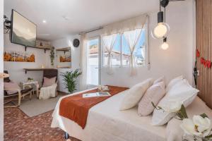 a bedroom with a bed and a living room at Studio with Terrace & Stunning Views in Güéjar-Sierra