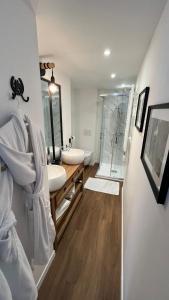 a bathroom with two sinks and a shower at Chez Patou in Laval