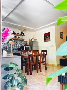 a dining room with a table and chairs at Garden view double room in Agadir +18 photos